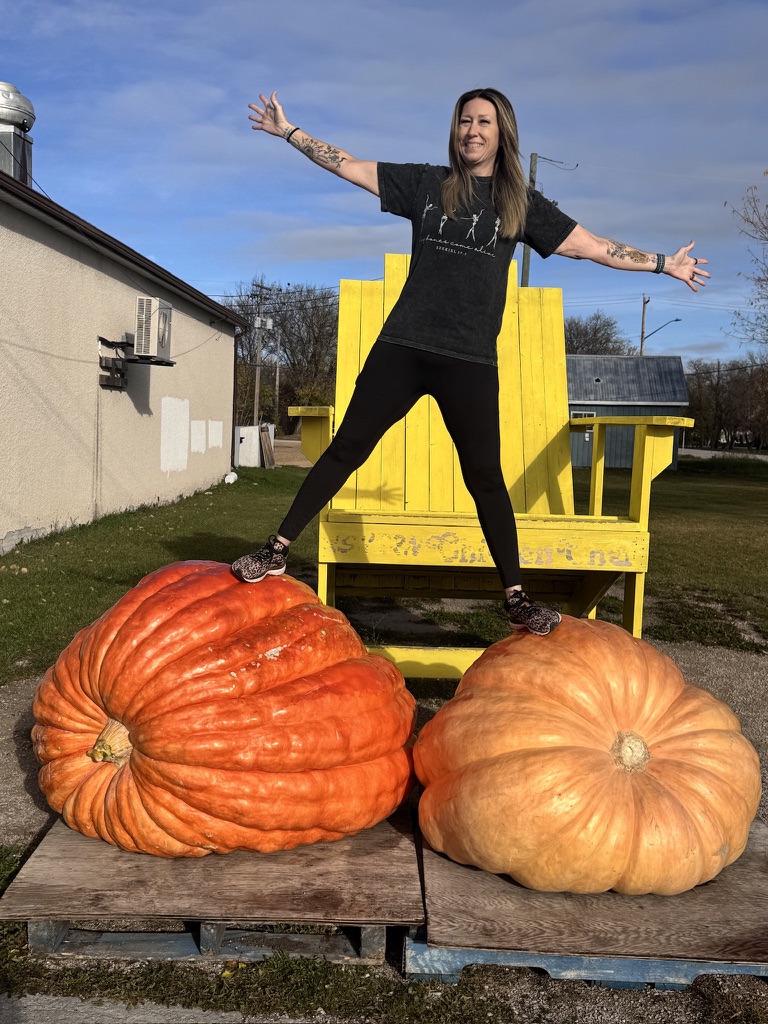 Catherine Noordenbos, co-owner of SamsSon Repair, with giant pumpkins
